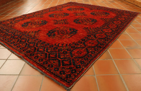 Strong burnt orange ground through the entirety of this rug.  The 6 motifs and the broad border uses a deep blue with bright green highlights.